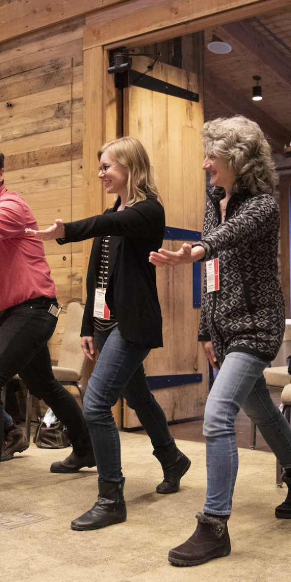 People do an exercise at an SJN Summit