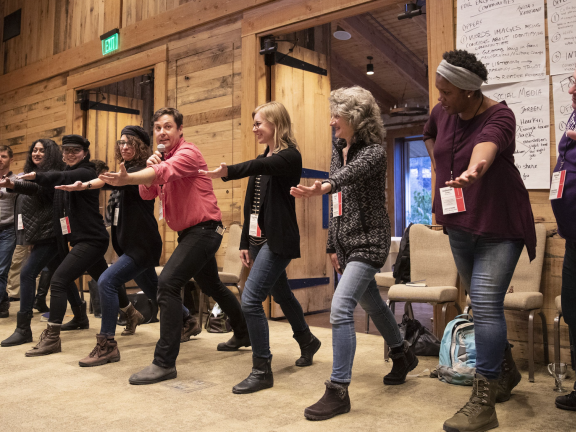 People do an exercise at an SJN Summit