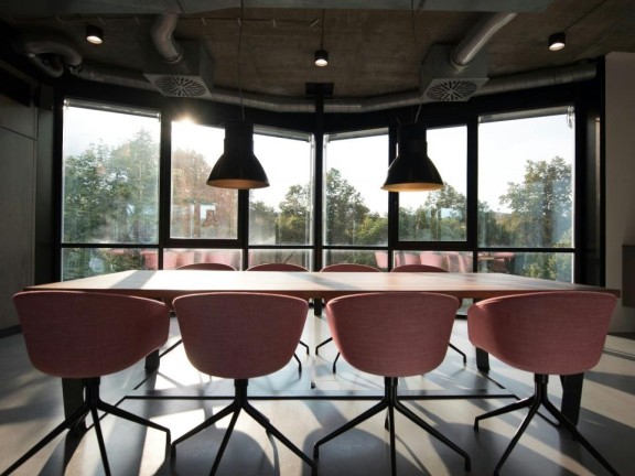 Empty chairs surround a conference table