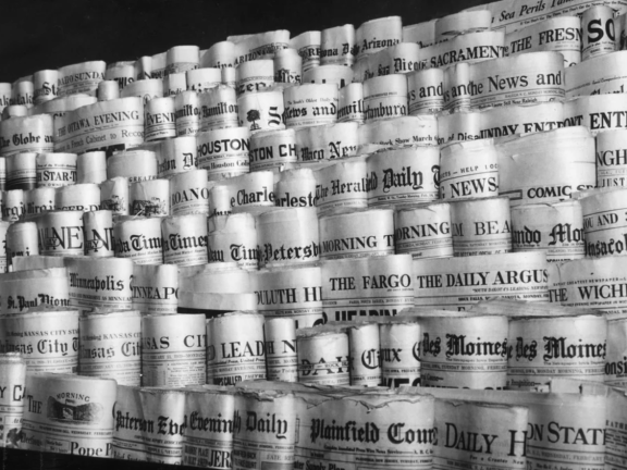 Newspapers are rolled and displayed