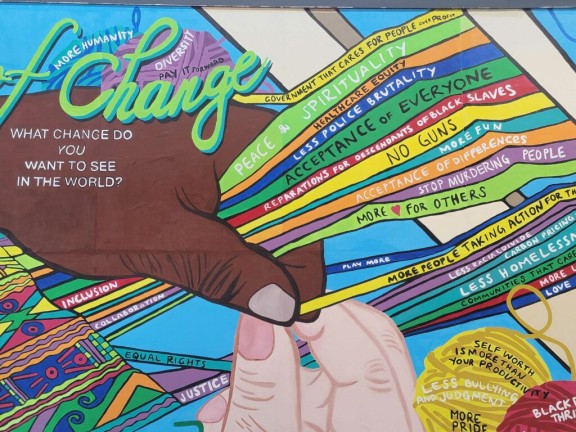 Colorful mural at Cherry Street Pier in Philadelphia shows two human hands, one Black and one white