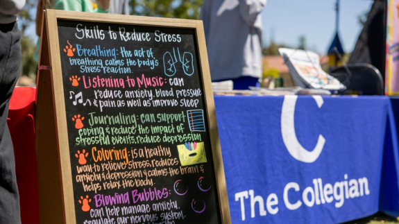 A sign at a campus event describes ways to reduce stress. Photo by Jacqueline Carrillo/The Collegian.