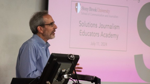 A man speaks at a podium