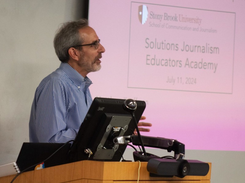 A man speaks at a podium