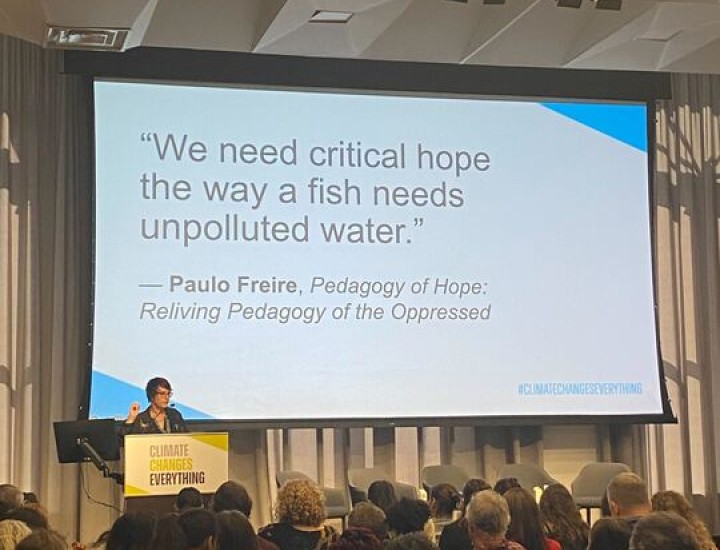 A quote is shown on a presentation slide, "We need critical hope the way a fish needs unpolluted water" by Paulo Freire 