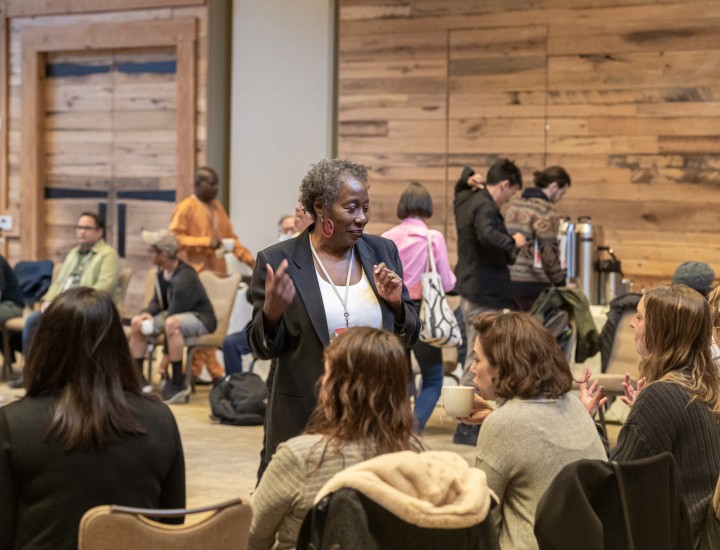 Participants in the 2022 SJN Summit speak with each other in a conference room