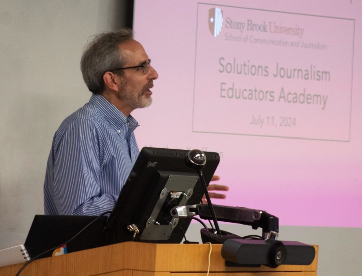 A man speaks at a podium