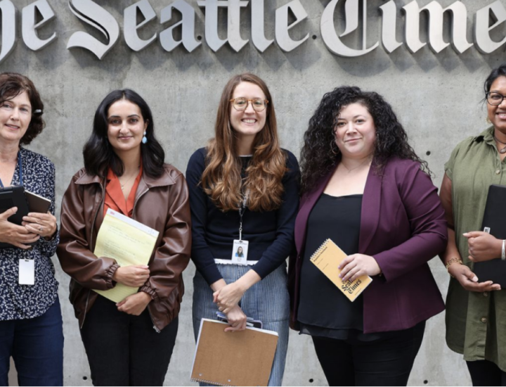 Reporters and editors stand in front of The Seattle Times