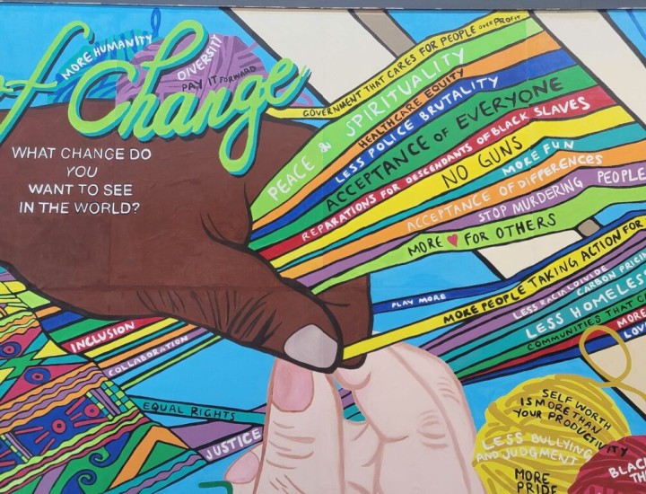 Colorful mural at Cherry Street Pier in Philadelphia shows two human hands, one Black and one white